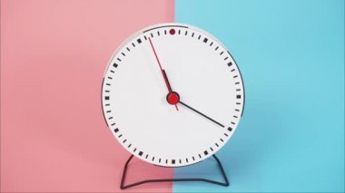 Time lapse,White wall clock shows the running of time. The movement of the hands of the clock passed quickly. On the two tone  background.