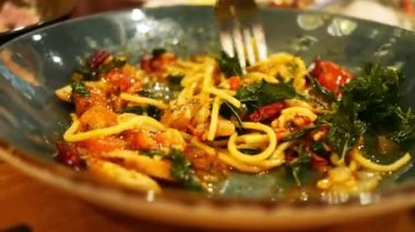 Spaghetti with spicy seafood in a plate with a fork. Seafood with Spaghetti and Spices.