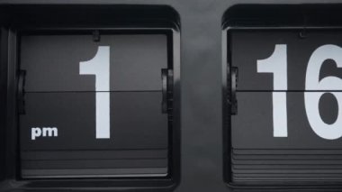 Time lapse, Close up, The black clock is telling the time.  From minutes to hours in clock style. On arabic number.