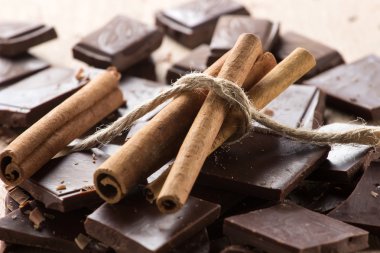 Chocolate with cinnamon sticks, selective focus