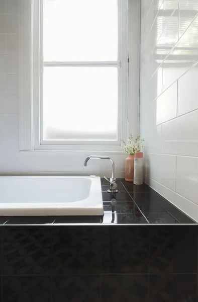 Close up details of balck tiled bath hob in renovated bathroom — Stock Photo, Image