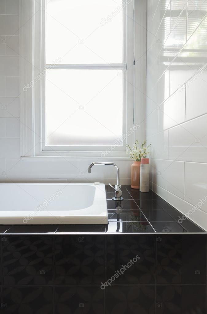Close up details of balck tiled bath hob in renovated bathroom — Stock