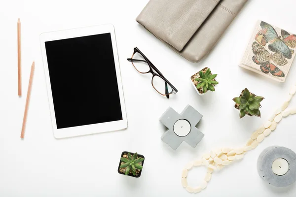 Blank tablet flat lay with desktop objects