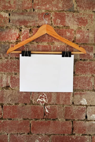 Blank retail sign hanging on coat hanger — Stock Photo, Image