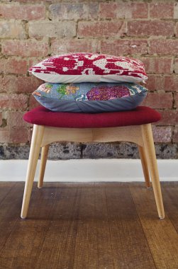 Homewares cushions on ottoman stool clipart