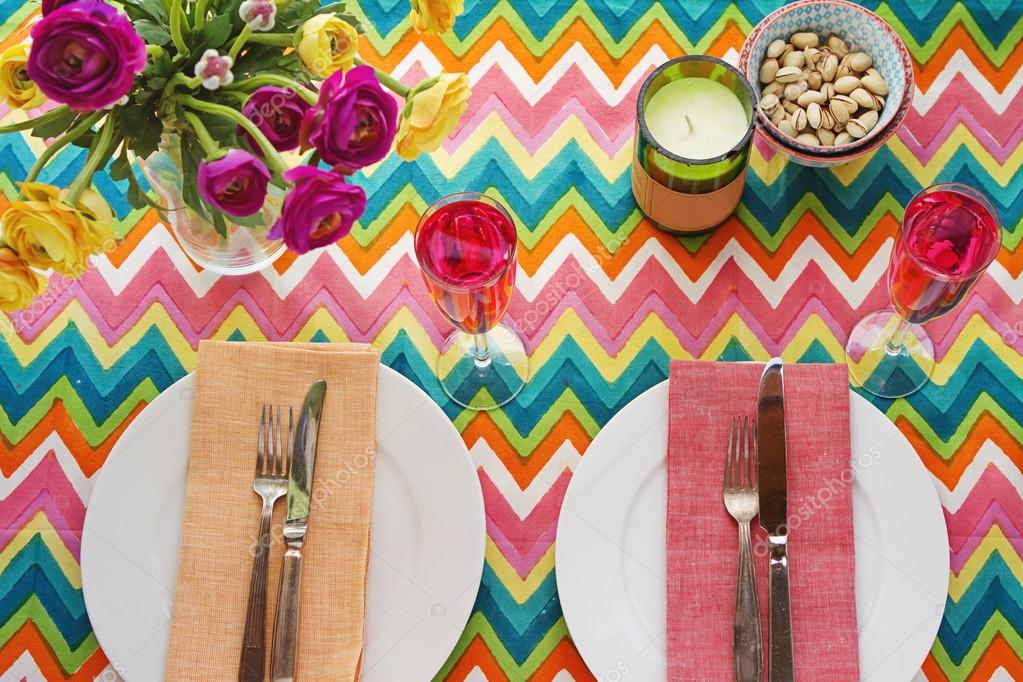 Overhead Bright colorful table setting with chevron tablecoth — Stock Photo © jodiejohnson 65329171