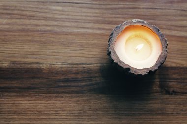 Overhead of a burning decorative candle clipart