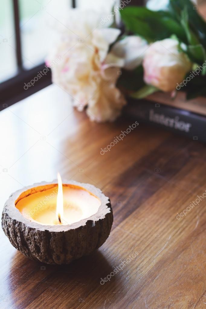 Burning candle on buffet home interior