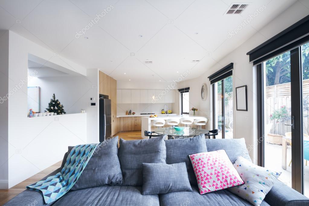 Comfortable grey sofa in open plan living room contemporary home