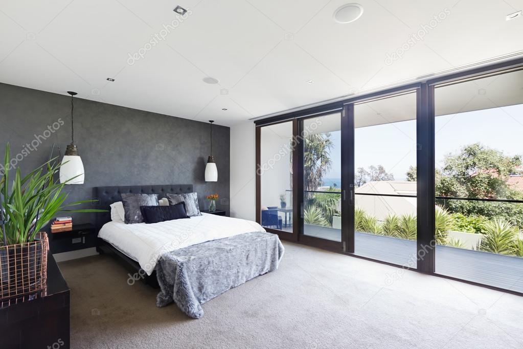 Spacious interior of designer master bedroom in luxury Australia Stock