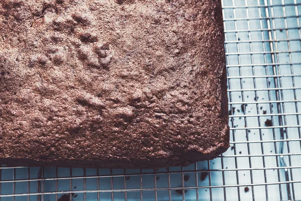 Close up overhead of chocolate brownie cake on wire rack