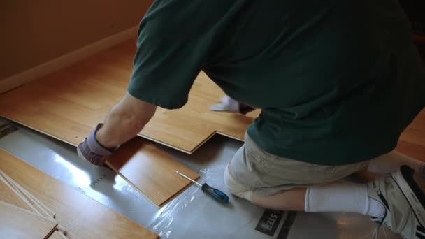Over Shoulder Of Workman Removing Laminate Flooring