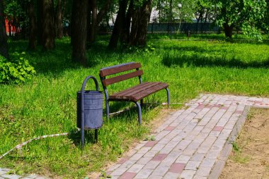bench and trash urn in the park, summer