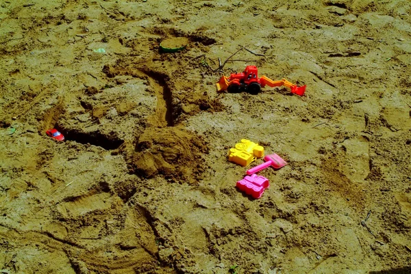 children\'s plastic molds in the sandbox, in the summer