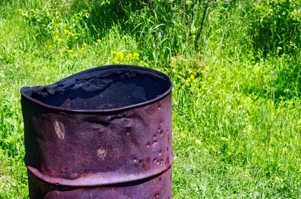 iron barrel for burning garbage in the garden, in the summer