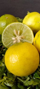 Dilimlenmiş Limonlar ve Koyu Arkaplanda Yeşil Yapraklar