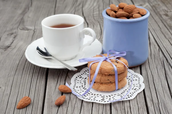 Galletas con chispas de chocolate y almendras con taza de té —  Fotos de Stock