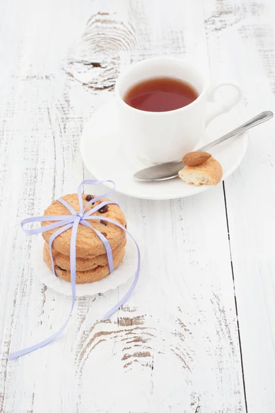 Galletas con chispas de chocolate en un plato blanco con taza de té —  Fotos de Stock