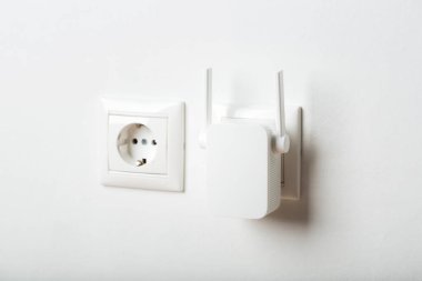 Beyaz kablosuz ağ yineleyici evde, prizde. kablosuz yönlendirici.