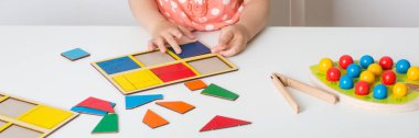 small baby child plays games for development of fine motor skills and spatial thinking. teaching preschool kids. long banner.