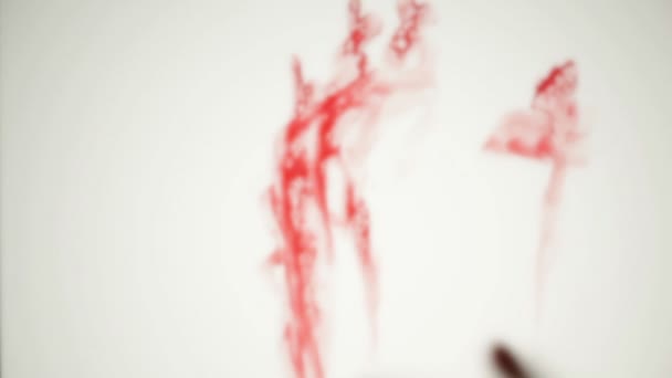 Blood-smeared defocused hand behind frosted glass — Stock Video