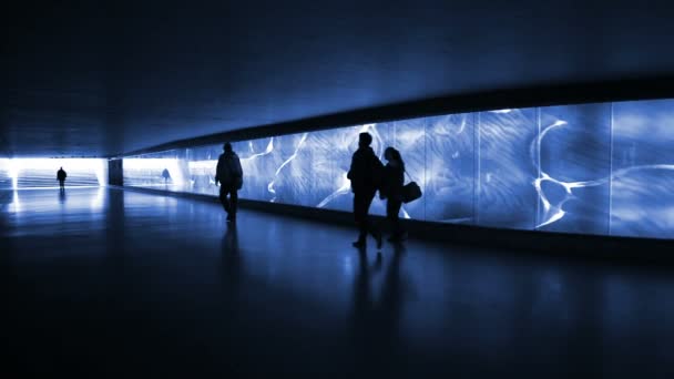 Blue illuminated underpass, subway - people walking by — Stock Video