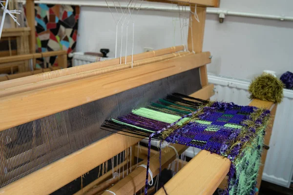 Close up on threads on weaving loom - traditional rug cloth and fabric making