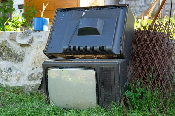 Dökülen çöpler Duvara atılan eski televizyonlar ve gündüz teknolojisiyle yıkılan çöpler geri dönüşüme hazır elektronik atıklar ya da kirlilik yaratan iki televizyon.