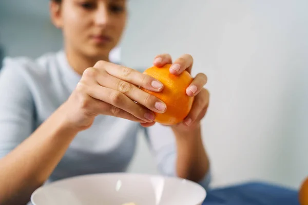 Close Sulle Mani Della Giovane Donna Peeling Arancione Tavolo Casa — Foto Stock