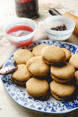 Marmelatlı ev yapımı kurabiyeler veya bir tabakta meyveli erik reçeli - yakın çekim tatlı yemek geleneksel yemek tarifi - sağlıklı yeme konsepti