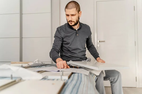 One Man Beard Alone Sitting While Putting Together Self Assembly — Fotografia de Stock