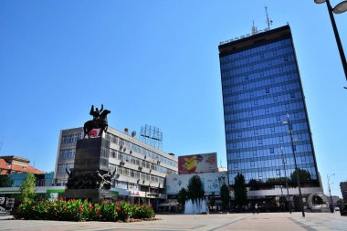 Nis, Serbia - August 08, 2021 Downtown area with the monument and big building on a sunny summer day in the city of Nis clipart