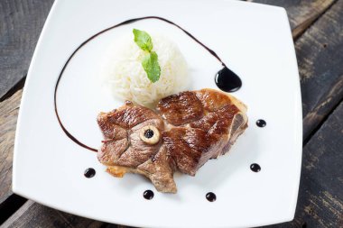 Geleneksel kuzu pirzolası, kebap, köfte ve ızgarada pilav ile servis edilir. Beyaz plakalı servis. Izgara kuzu üst görünümü