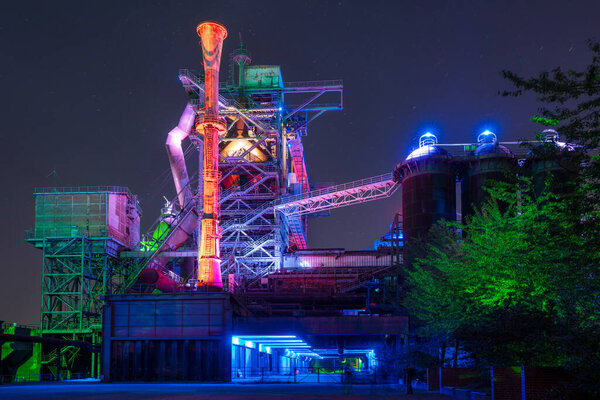DUISBURG, GERMANY - SEPTEMBER 18, 2020: Industrial heritage of the old economy, illuminated ruin of steelmill in the Landschaftspark Duisburg on September 18, 2020 in Ruhr Metropolis, Germany, Europe