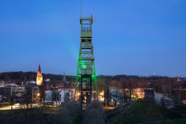 CASTROP-RAUXEL, GERMANY - December 5, 2020: Old headframe of Erin pit, landmark of Ruhr Metropolis Castrop-Rauxel against evening sky on December 5, 2020 in Germany clipart