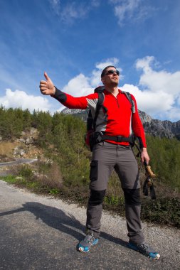 otostopçu Gezgin dağ yolda arabayı durdur çalışın