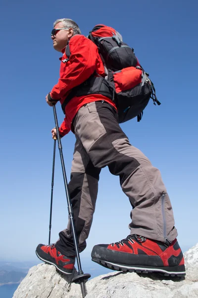 Escursionista in piedi sulla cima della montagna con valle sullo sfondo . — Foto Stock