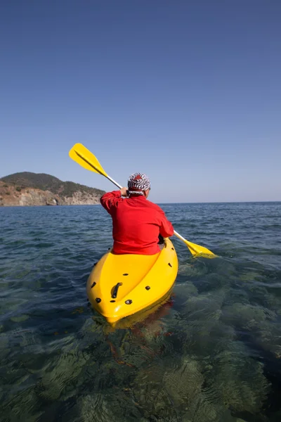 Ung kaukasisk man kajakpaddling i havet på Maldiverna — Stockfoto