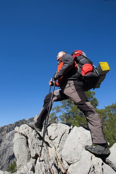 Hiker standing on top of the mountain with valley on the background. — Stock Photo, Image