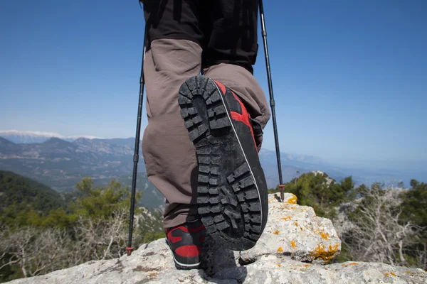 Hiker standing on top of the mountain with valley on the background. — Stock Photo, Image