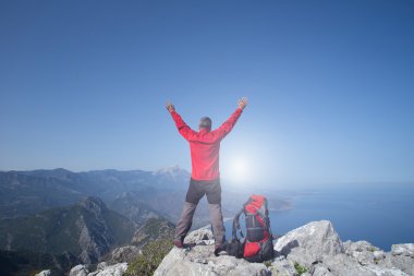 Gezgin bir dağın tepesinde güneş doğarken görünüyor. Dawn dağlarda.