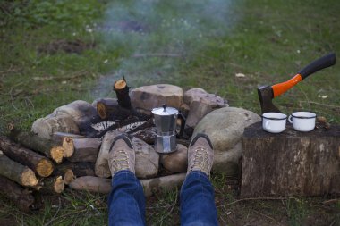Bir kamp ateşi kamp alanında haritaya bakıyordum ve kahve içme yakın oturan kız.