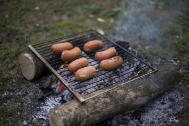 Ateşte sosis pişirme.
