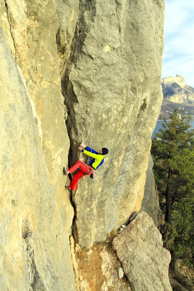 Cliffhanger.Rock klättrare klättra väggen. — Stockfoto