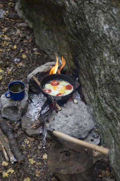 Cooking breakfast.Cooking breakfast on a campfire at a summer camp.