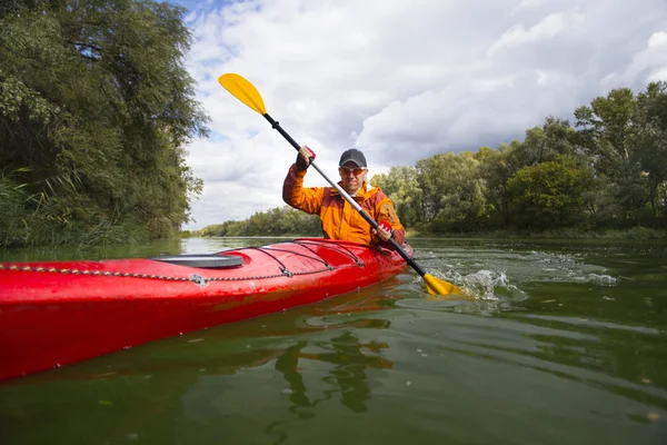 Kayak sur la rivière.Jeune homme pagayant dur le kayak avec beaucoup d'éclaboussures . — Photo