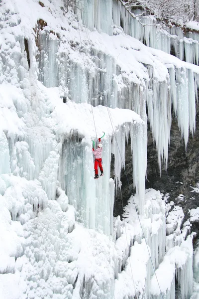 Mann klettert auf gefrorenen Wasserfall — Stockfoto