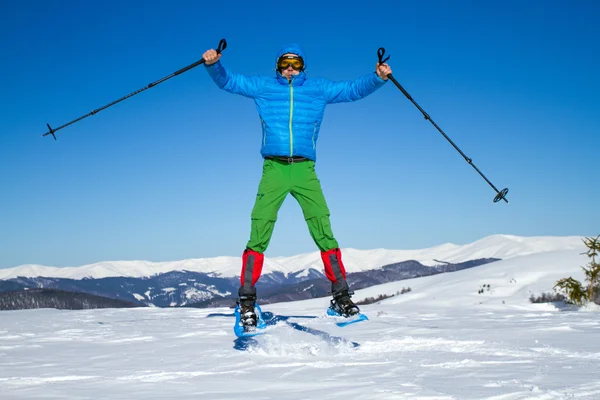 Winter hiking in the mountains on snowshoes with a backpack and tent. — Stock Photo, Image