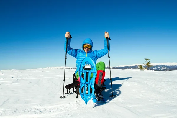 Winter hiking in the mountains on snowshoes with a backpack and tent. — Stock Photo, Image