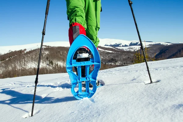 Winter hiking in the mountains on snowshoes with a backpack and tent. — Stock Photo, Image